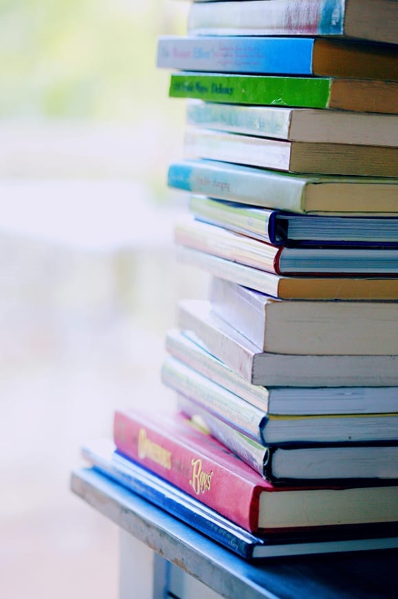 Stack of colorful books representing publications and research materials